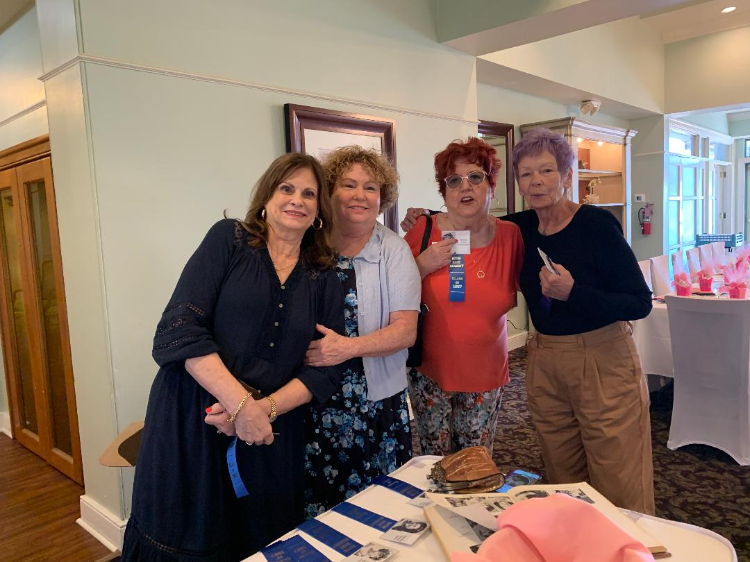 Patty Masi DeWItt, Shirley Barnaby Rigo, Noreen Tracy LaPiccerella, Kathy Kochanski Turner are picking up nametags and obviously ready to party!